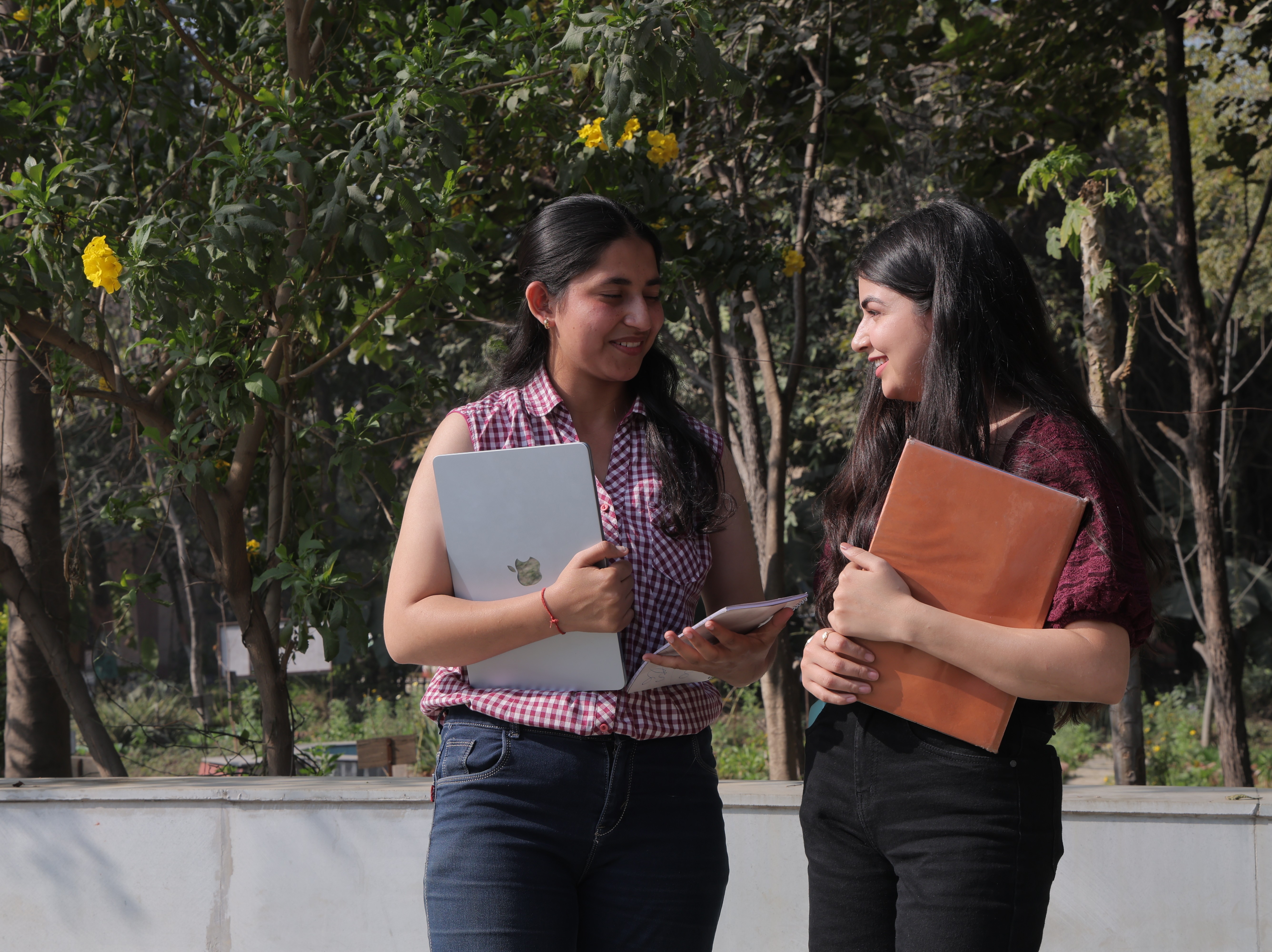 BBA Students at Ishan IIMT, Greater Noida discussing career goals in a campus learning environment. front