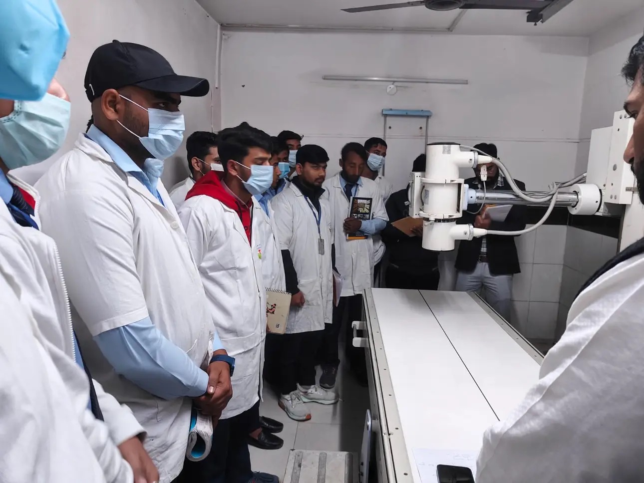 Ishan Institute of Pharmacy students exploring advanced laboratory equipment during educational industrial visit. front